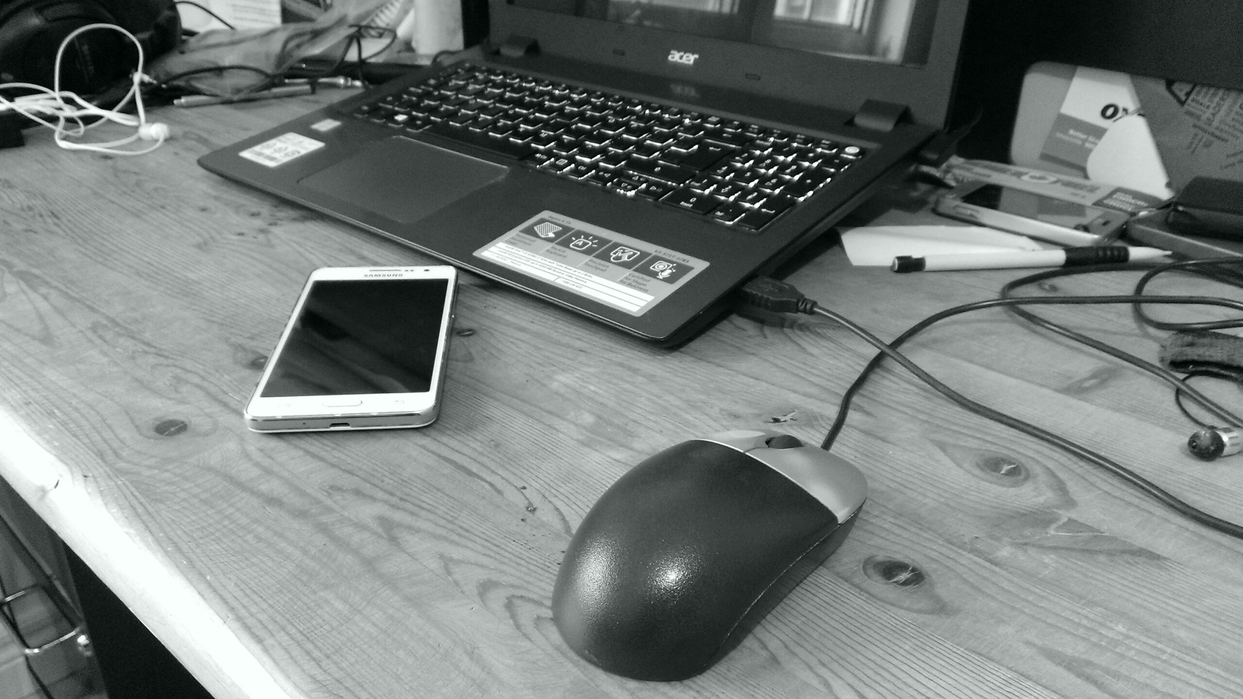 Laptop, computer mouse and telephone on a desk.